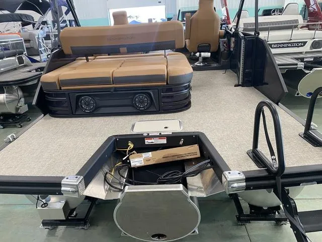 Slide: The Image of 2025 Bennington 24' MSB Tri-Toon boat interior with seating and storage area. - 8
