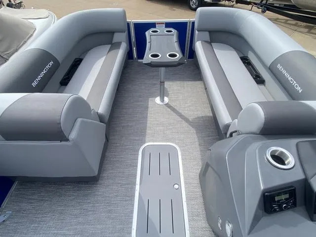 Slide: The Image of 2024 Bennington 20 SVSR-SPS pontoon boat interior with gray seating and steering console. - 8