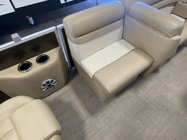 Slide: The Image of 2016 Bennington 24 SSRX boat interior with beige seating and cup holders. - 10