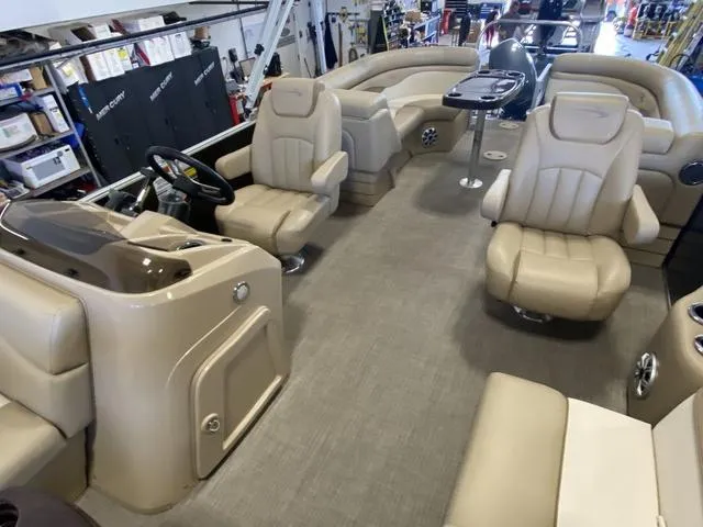 Slide: The Image of Interior of a 2016 Bennington 24 SSRX pontoon boat with beige seating and helm. - 12