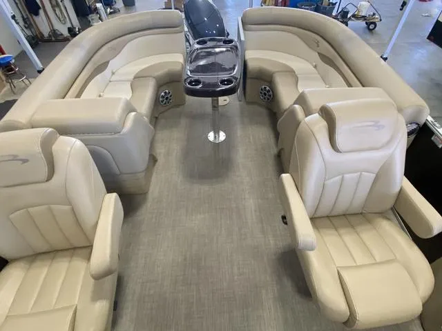 Slide: The Image of 2016 Bennington 24 SSRX boat interior with beige seating and central console. - 14