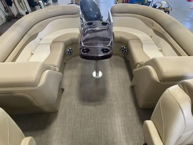 Slide: The Image of Interior of 2016 Bennington 24 SSRX pontoon boat with beige seating and central table. - 15