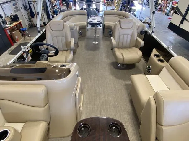 Slide: The Image of 2016 Bennington 24 SSRX pontoon boat interior with beige seating and steering console. - 5
