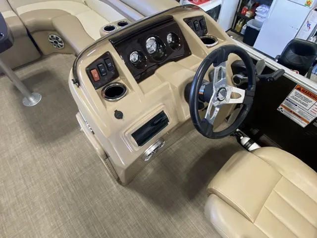 Slide: The Image of 2016 Bennington 24 SSRX boat interior with steering wheel and control panel. - 8