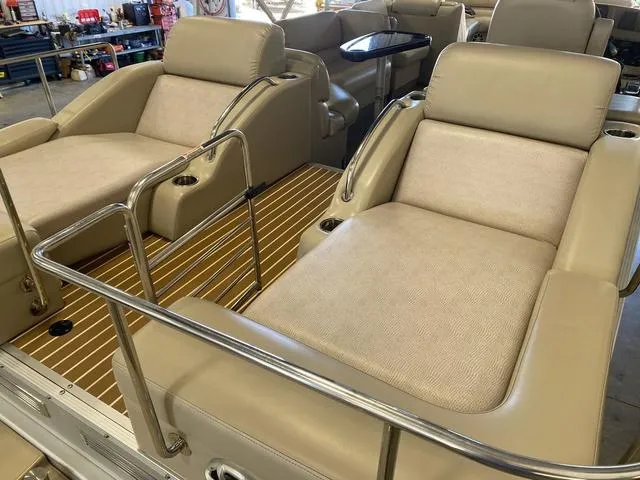 Slide: The Image of 2012 Bennington 25 RCW-I/O boat interior with beige seating and wood flooring. - 10