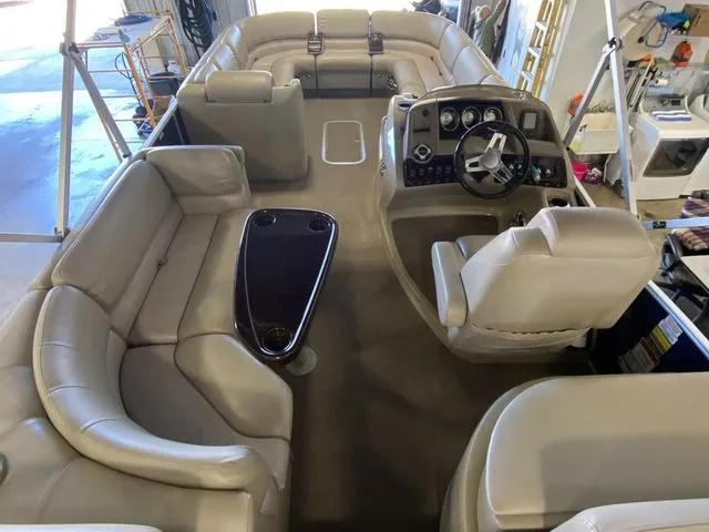 Slide: The Image of 2012 Bennington 25 RCW-I/O boat interior with plush seating and modern dashboard. - 11
