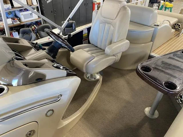 Slide: The Image of Interior of a 2012 Bennington 25 RCW-I/O boat with beige seating and steering console. - 16
