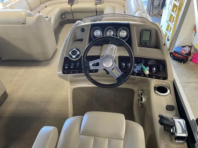 Slide: The Image of Interior of a 2012 Bennington 25 RCW-I/O boat, featuring a sleek steering console. - 17