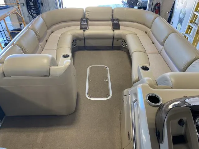 Slide: The Image of 2012 Bennington 25 RCW-I/O boat interior with beige seating and cup holders. - 18