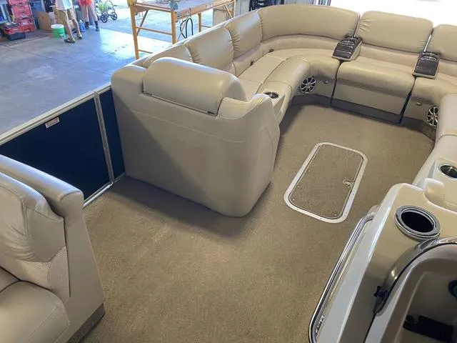 Slide: The Image of Interior of a 2012 Bennington 25 RCW-I/O pontoon boat with beige seating. - 19
