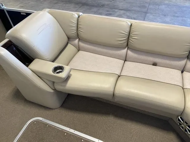 Slide: The Image of 2012 Bennington 25 RCW-I/O boat seating with beige upholstery and cup holder. - 20