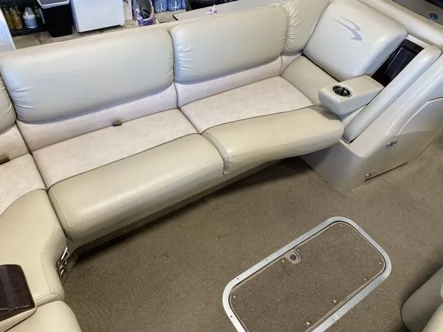 Slide: The Image of 2012 Bennington 25 RCW-I/O boat interior with beige seating and cup holder. - 21