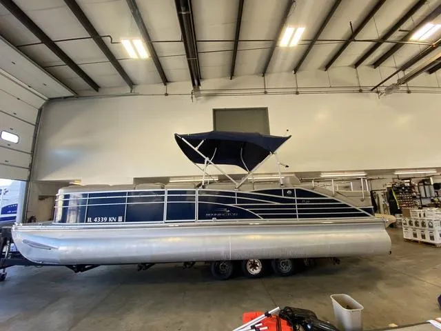 Slide: The Image of 2012 Bennington 25 RCW-I/O pontoon boat in a warehouse setting. - 3