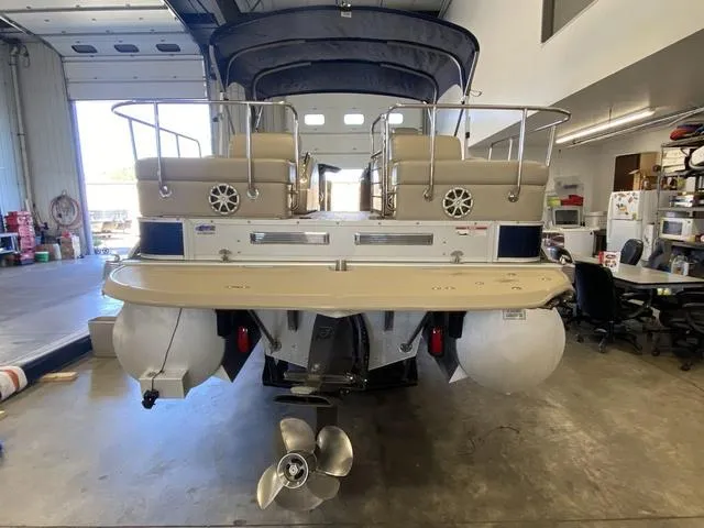 Slide: The Image of 2012 Bennington 25 RCW-I/O pontoon boat in a garage, rear view. - 5