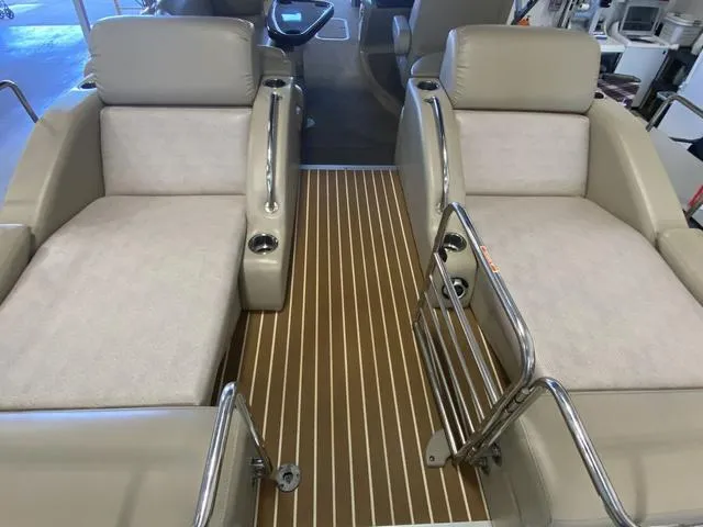 Slide: The Image of 2012 Bennington 25 RCW-I/O boat interior with beige seating and striped flooring. - 9