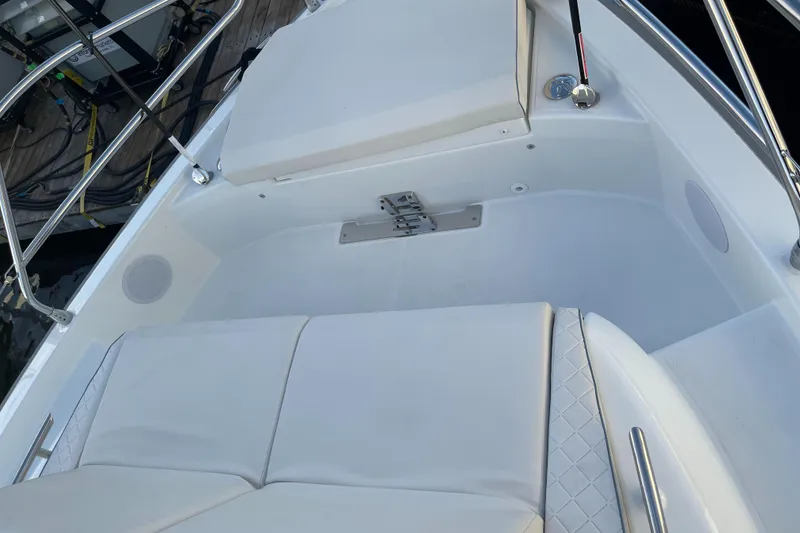Slide: The Image of 2025 Jeanneau DB/43 OB boat interior with white cushioned seating and stainless steel railings. - 15