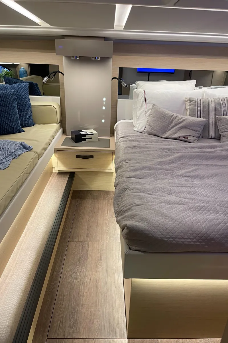 Slide: The Image of Luxurious interior of 2025 Jeanneau DB/43 OB yacht with modern bedding and ambient lighting. - 25