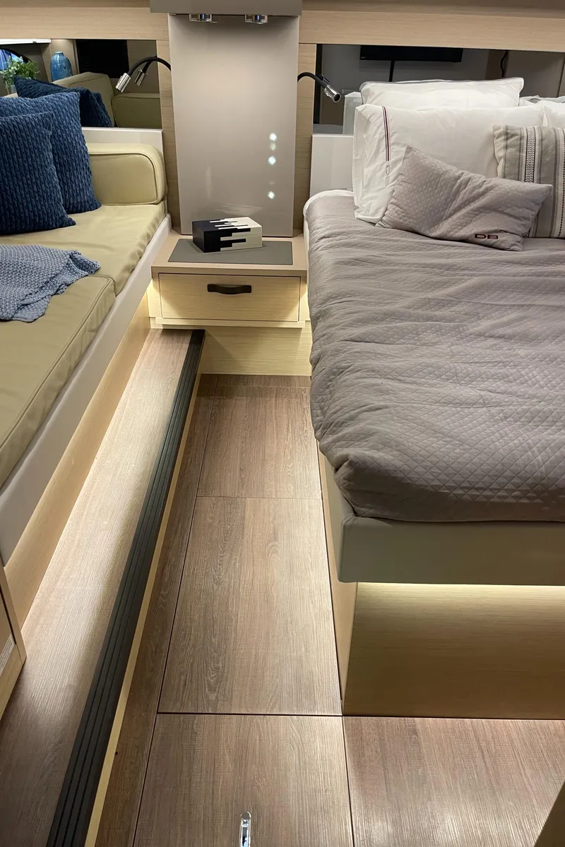 Slide: The Image of Interior of 2025 Jeanneau DB/43 OB yacht cabin with modern bedding and seating. - 26