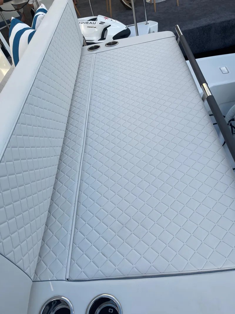 Slide: The Image of 2025 Jeanneau DB/43 OB boat with quilted white seating and cup holders. - 7