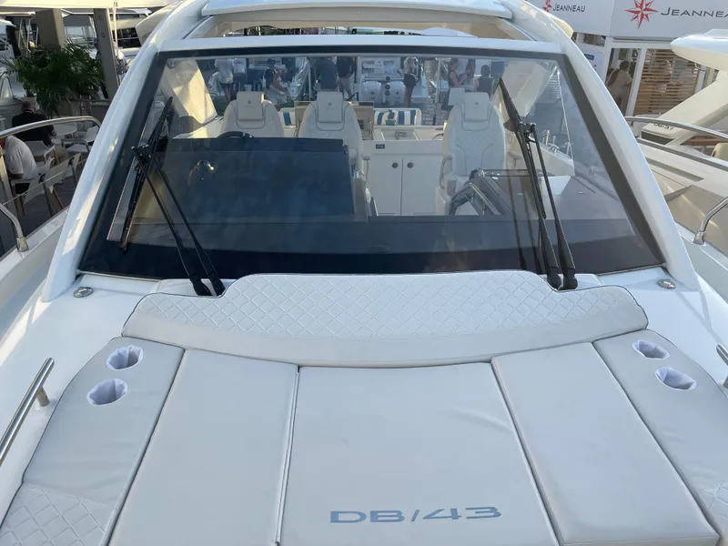 Slide: The Image of 2025 Jeanneau DB/43 OB luxury yacht with sleek design and spacious seating. - 9