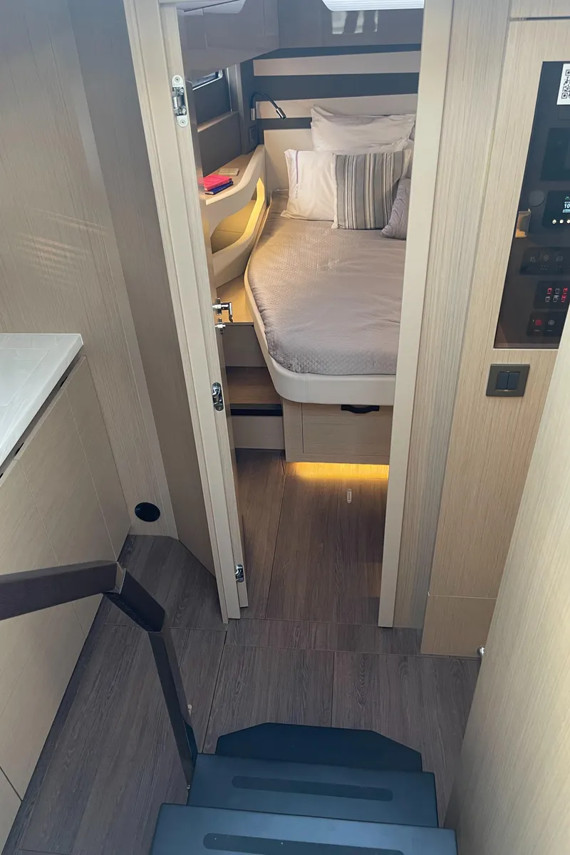 Slide: The Image of 2025 Jeanneau DB/43 OB cabin interior with bed and modern design. - 16