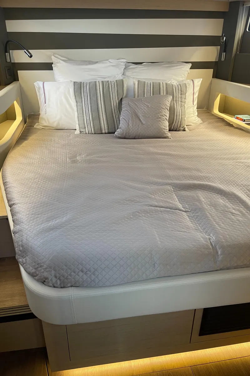 Slide: The Image of Luxurious bedroom interior of 2025 Jeanneau DB/43 OB yacht with modern bedding. - 17