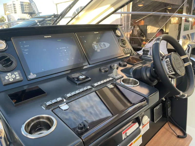 Slide: The Image of 2025 Jeanneau DB/43 OB helm with advanced navigation displays and controls. - 5