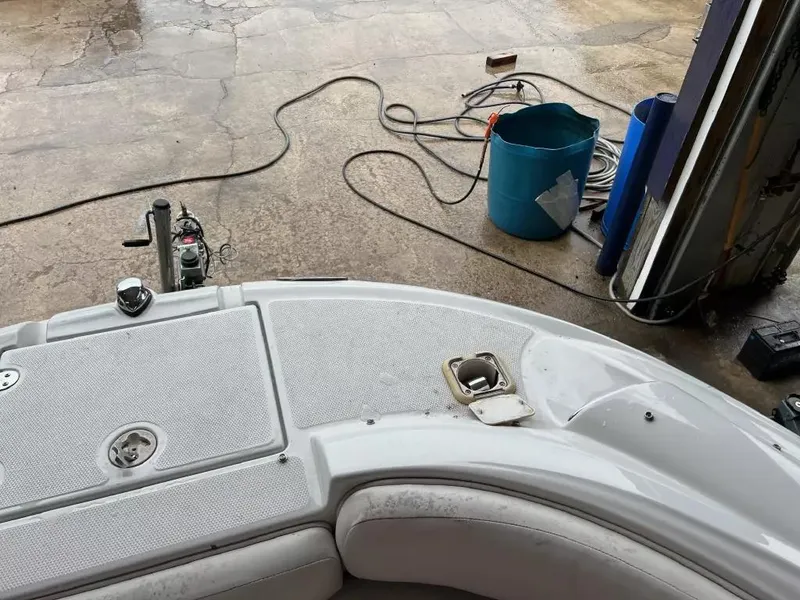 Slide: The Image of 2003 Crownline 230 BR boat interior with maintenance tools and bucket nearby. - 14