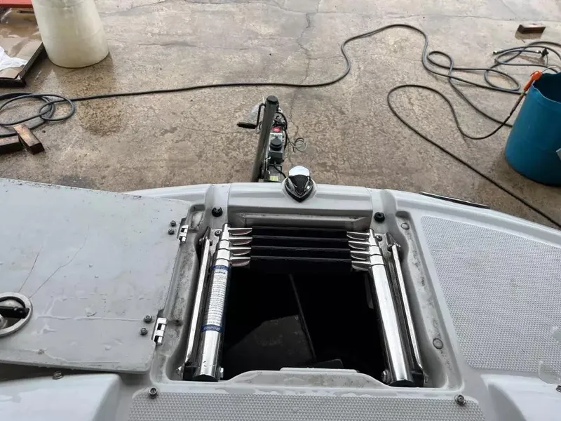 Slide: The Image of Open hatch on 2003 Crownline 230 BR boat with visible ladder and dock equipment. - 15