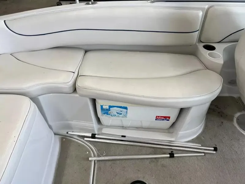 Slide: The Image of 2003 Crownline 230 BR boat interior with white seating and storage compartment. - 18