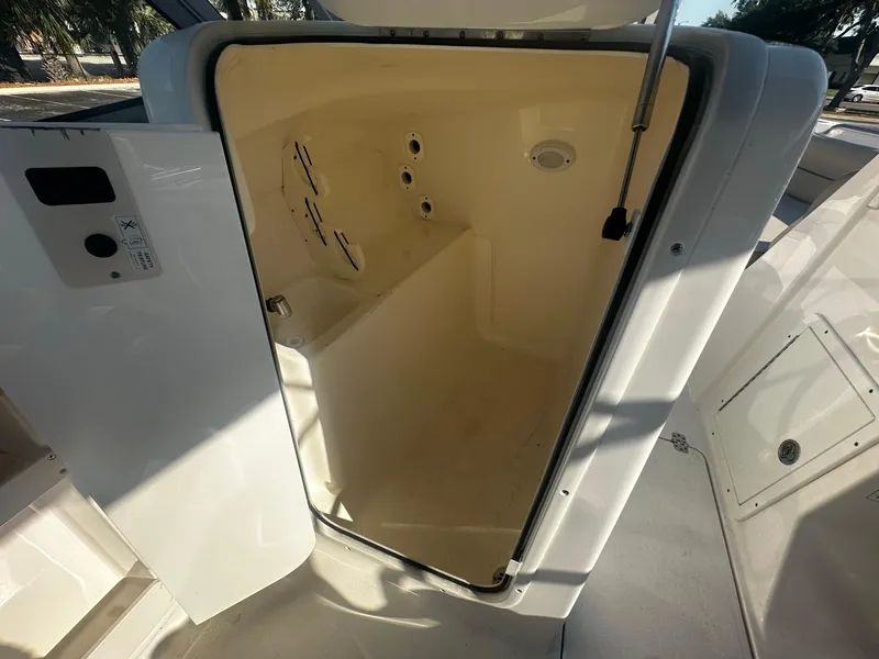 Slide: The Image of 2022 Key West 239 DFS boat interior storage compartment with open door. - 11