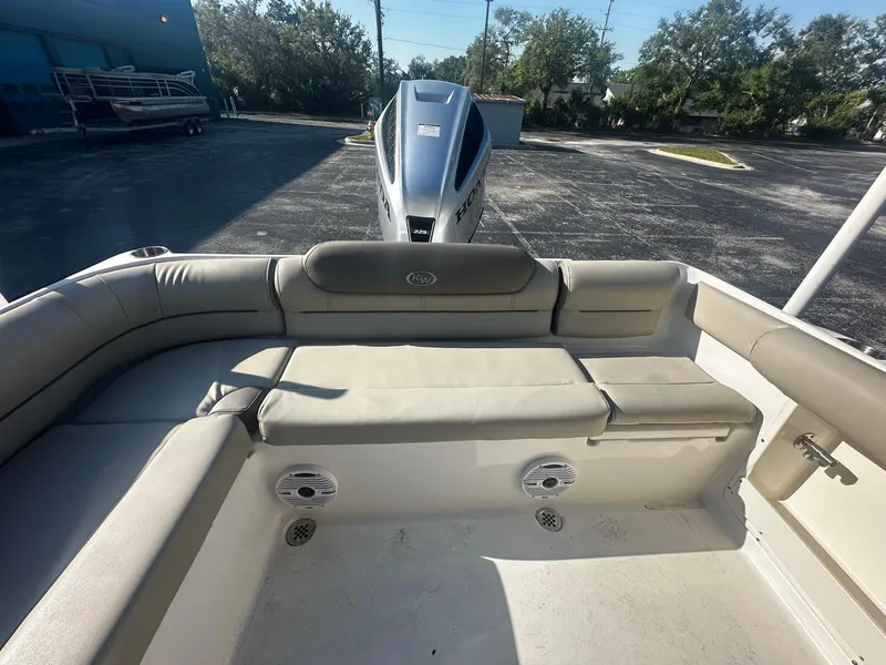 Slide: The Image of 2022 Key West 239 DFS boat interior with cushioned seating and outboard motor. - 8