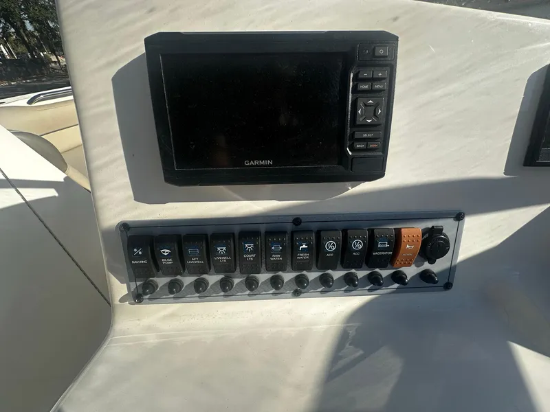 Slide: The Image of Control panel of 2022 Key West 239 DFS boat with Garmin display and switches. - 9