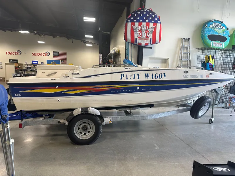 Slide: The Image of 2007 Bayliner 197 boat on trailer in showroom, labeled "Party Wagon." - 0