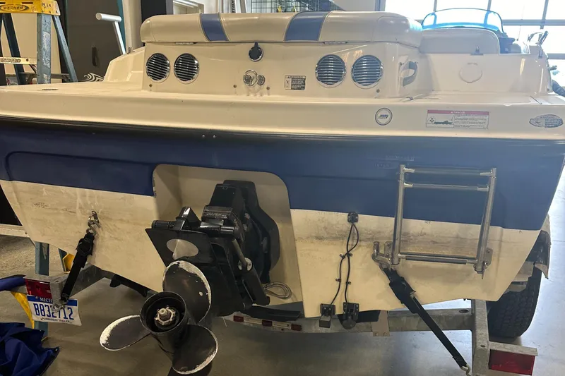 Slide: The Image of 2007 Bayliner 197 boat rear view with propeller and ladder. - 11