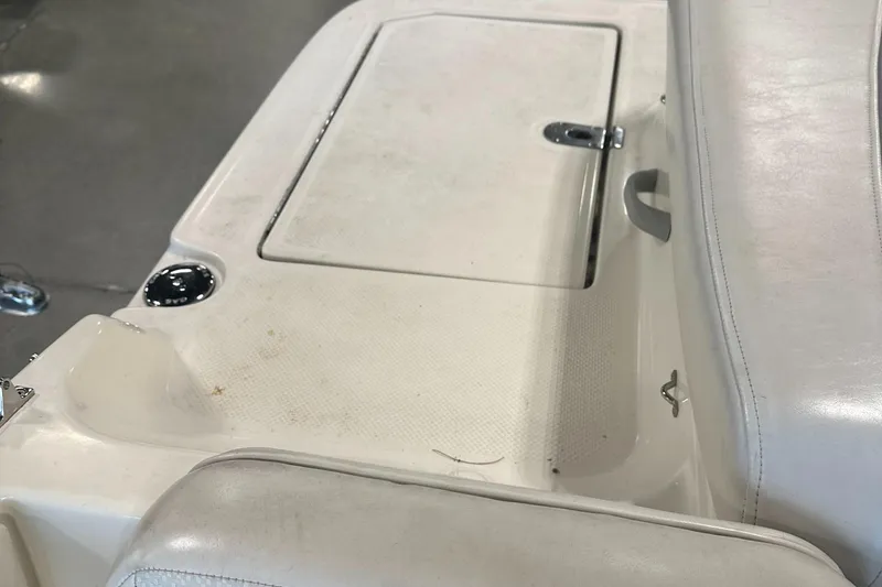 Slide: The Image of 2007 Bayliner 197 boat interior with white seating and storage compartment. - 7