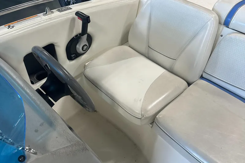 Slide: The Image of 2007 Bayliner 197 boat interior with steering wheel and seating. - 9