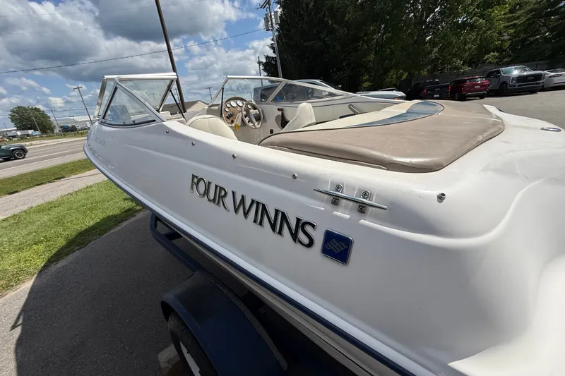 Slide: The Image of 1997 Four Winns 170 Horizon Ski/Fish boat parked outdoors on a sunny day. - 10