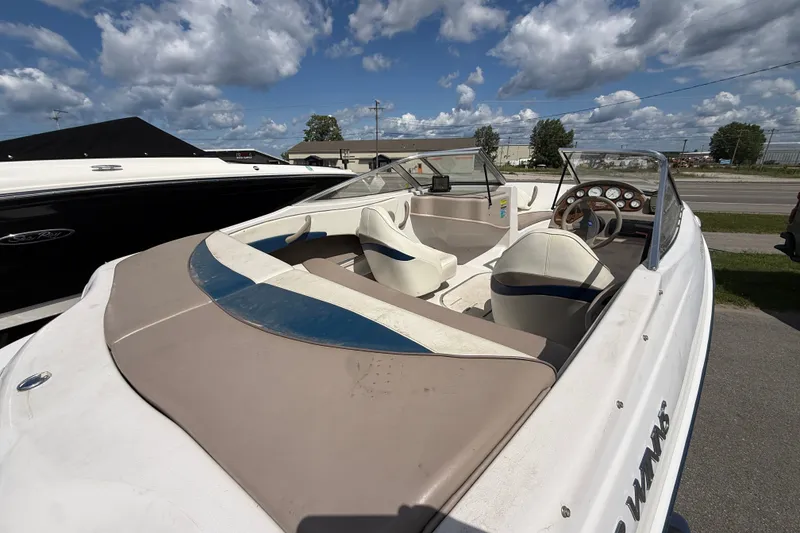 Slide: The Image of 1997 Four Winns 170 Horizon Ski/Fish boat with beige and blue interior under cloudy sky. - 9