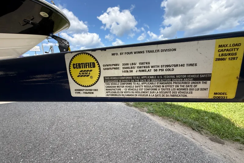 Slide: The Image of 1997 Four Winns 170 Horizon Ski/Fish trailer certification label with safety standards and load capacity. - 17