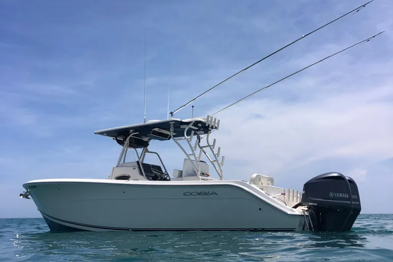 Slide: The Image of 2014 Cobia 296 Center Console boat on calm ocean waters. - 0