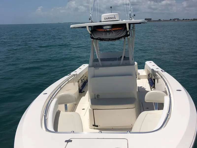 Slide: The Image of 2014 Cobia 296 Center Console boat on open water, featuring Garmin equipment. - 2