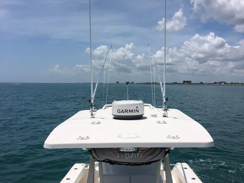Slide: The Image of 2014 Cobia 296 Center Console boat with Garmin equipment on open water. - 3