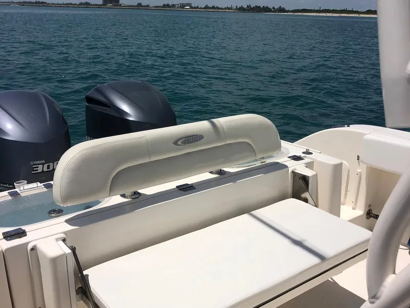 Slide: The Image of 2014 Cobia 296 Center Console boat with twin engines on open water. - 8