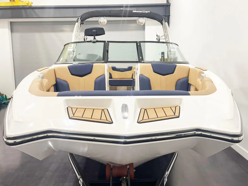 Slide: The Image of 2022 MasterCraft NXT24 boat on trailer in showroom. - 4