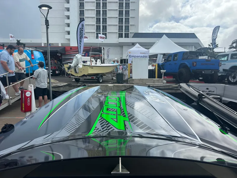 Slide: The Image of Nor-Tech 4000 Supercat 2025 at a boat show, surrounded by people and vehicles. - 16