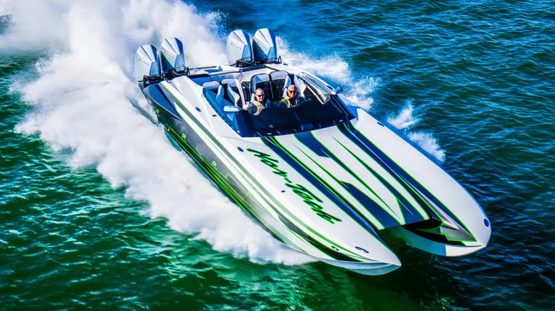 Slide: The Image of 2025 Nor-Tech 4000 Supercat speedboat racing on water, showcasing sleek design and powerful engines. - 2