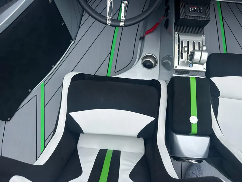 Slide: The Image of Interior of 2025 Nor-Tech 4000 Supercat with sleek black and green seating. - 21