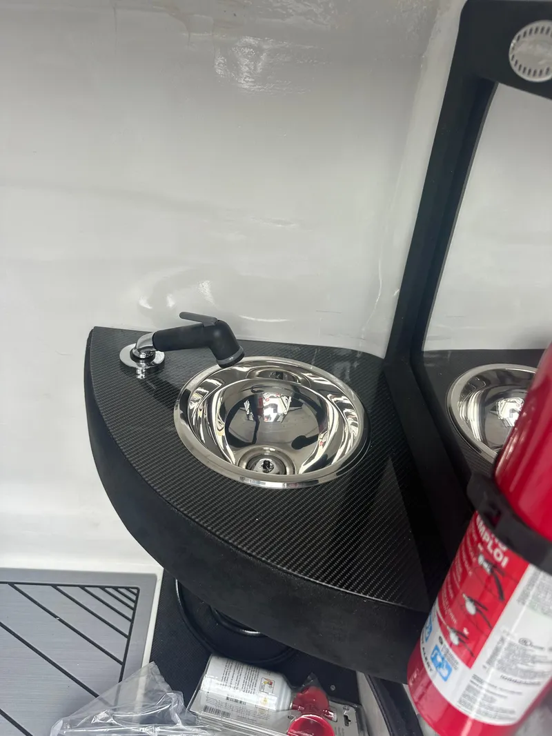 Slide: The Image of Compact sink area in 2025 Nor-Tech 4000 Supercat boat interior. - 27