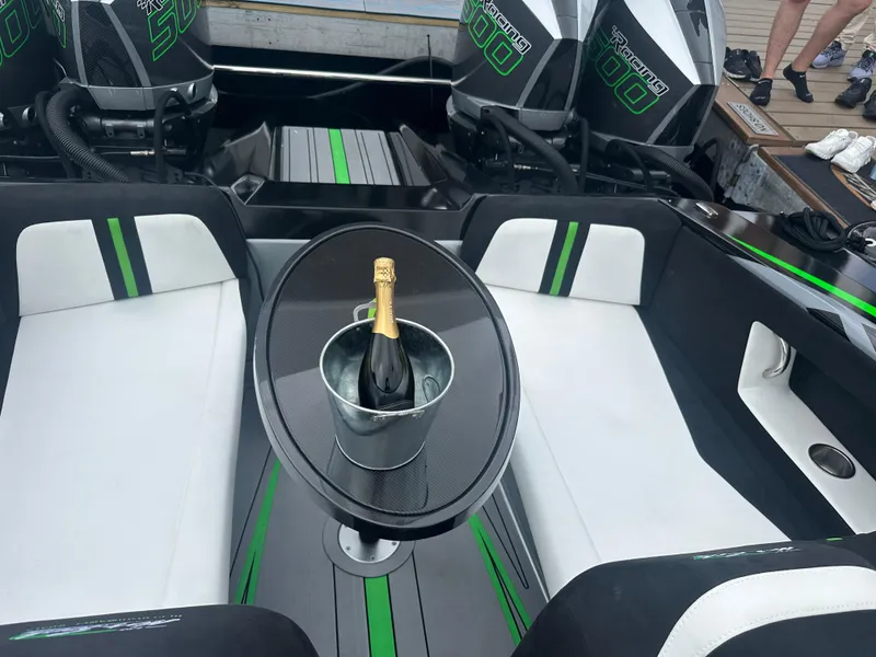Slide: The Image of Nor-Tech 4000 Supercat 2025 interior with champagne on table, luxury seating, and powerful engines. - 31